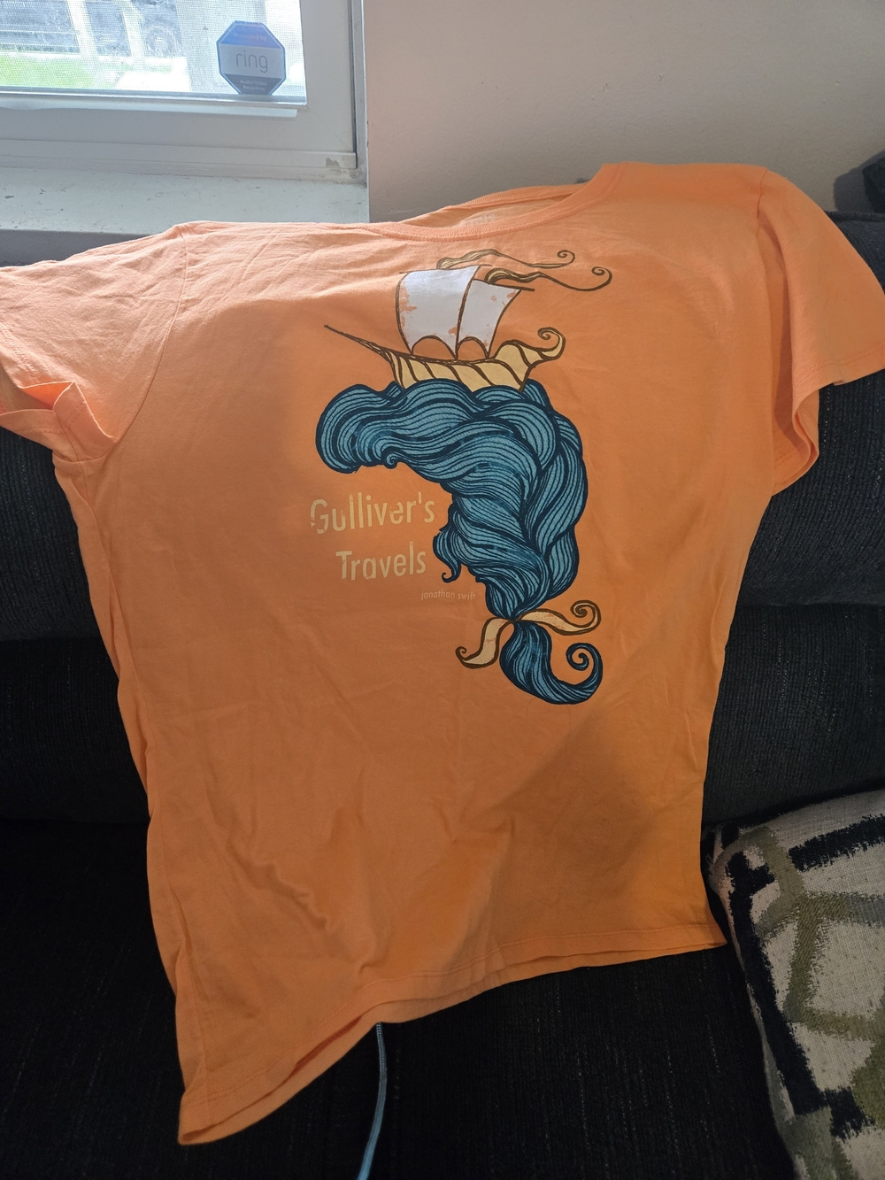 Gulliver's Travels Orange Graphic Tee with Blue Ship Illustration